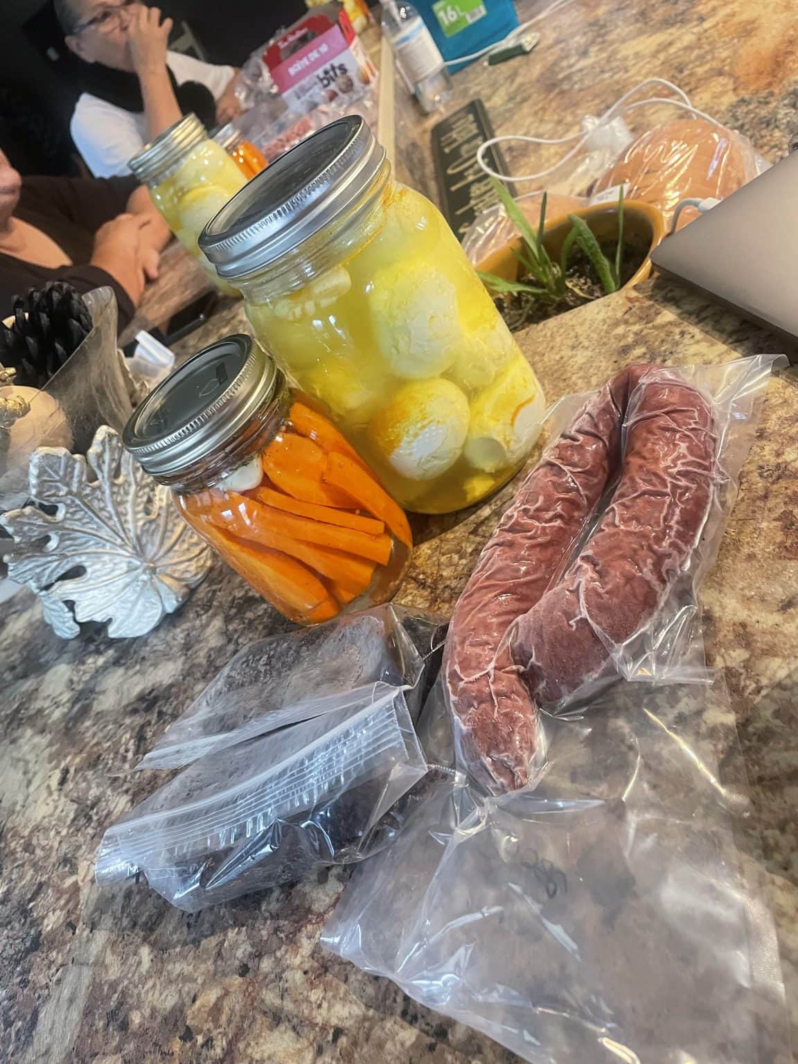 Canned carrots and garlic, and sausages in packaging