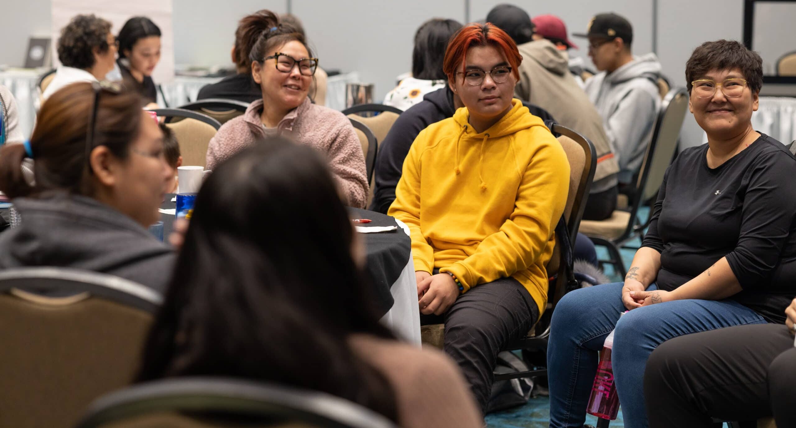 A room full of Inuit youth listening to a presentation