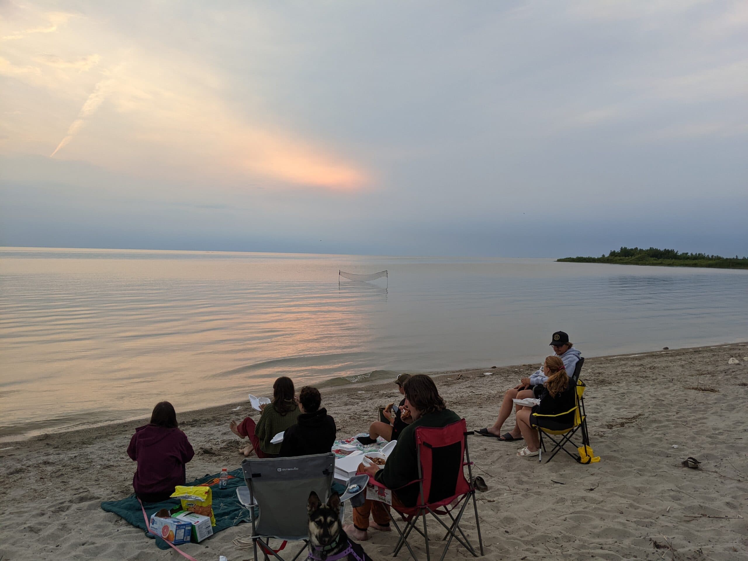 Metis youth sitting together and eating on the beach